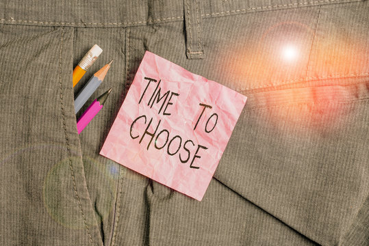 Text sign showing Time To Choose. Business photo text Judging the merits of multiple options and selecting one Writing equipment and pink note paper inside pocket of man work trousers