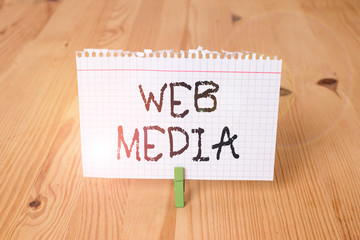Word writing text Web Media. Business photo showcasing audio and visual forms of communication presented on the web Empty reminder wooden floor background green clothespin groove slot office