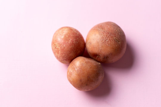 Cambray potatoes on pink background