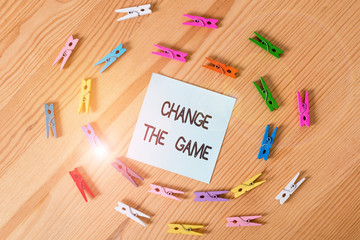 Writing note showing Change The Game. Business concept for Make a movement do something different new strategies Colored clothespin papers empty reminder wooden floor background office