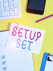 Writing note showing Setup Set. Business concept for the analysisner, position, or direction in which something is set Crumpled white paper on table paper clips clock mobile and pc keyboard