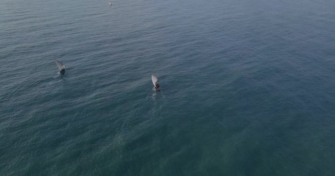 Traditional dhow sailboat sailing on the Indian ocean on the Swahili coast filmed with a drone, Tanzania.