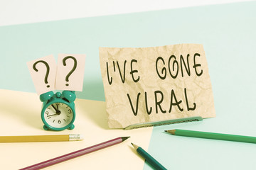 Conceptual hand writing showing I Ve Gone Viral. Concept meaning medical term used to describe small infectious agent Mini size alarm clock beside stationary on pastel backdrop