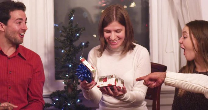 Young woman receives prank gift and gets made fun and mocked at holiday party - slow motion - shot on RED
