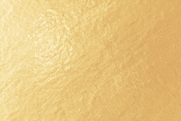 Gold foil paper texture. Light golden background