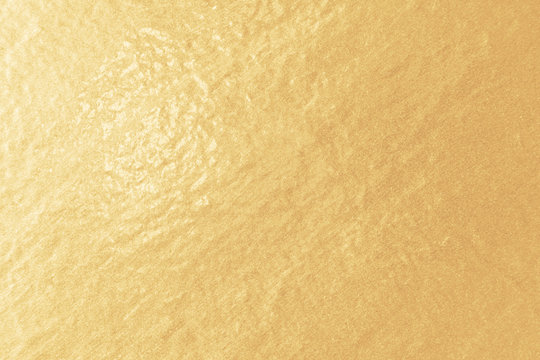 Gold foil paper texture. Light golden background