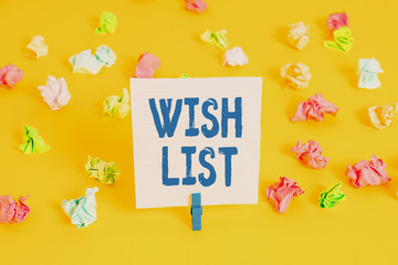 Word writing text Wish List. Business photo showcasing List of desired but often realistically unobtainable items Colored crumpled papers empty reminder white floor background clothespin