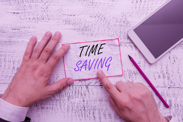 Writing note showing Time Saving. Business concept for the act of reducing the amount of time...