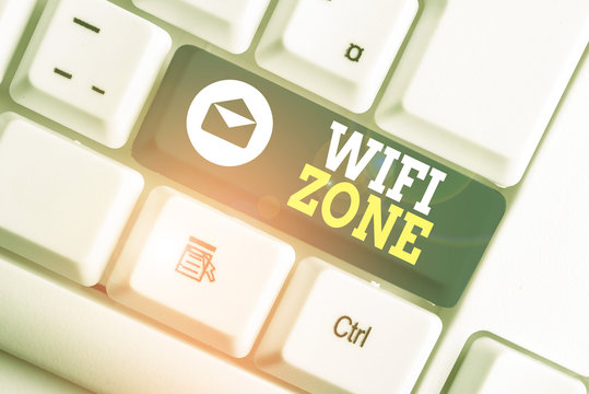 Word writing text Wifi Zone. Business photo showcasing provide wireless highspeed Internet and network connections White pc keyboard with empty note paper above white background key copy space
