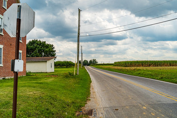 Fototapeta na wymiar Amish country Corn field, road and town in Lancaster, PA US