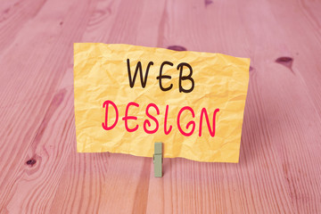 Conceptual hand writing showing Web Design. Concept meaning Website development Designing and process of creating websites Wooden floor background green clothespin groove slot office