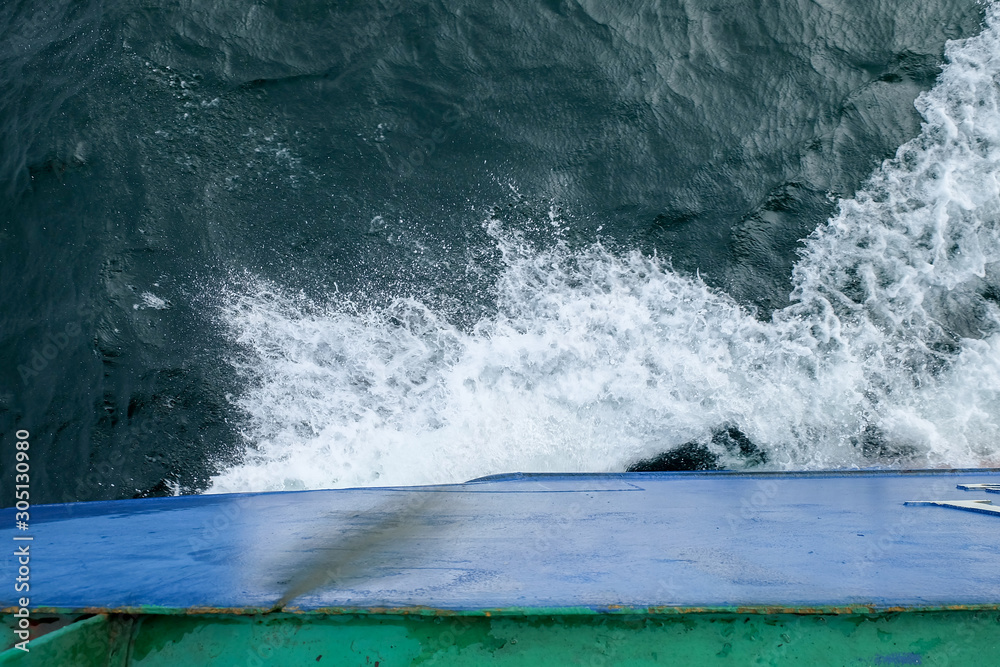 Wall mural starboard side of a ferry boat on the south china sea being hit hard by waves in the evening.