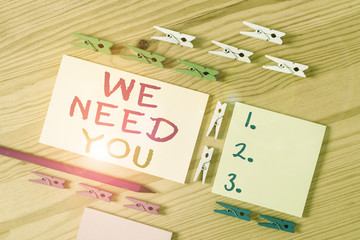 Text sign showing We Need You. Business photo showcasing Company wants to hire Vacancy Looking for talents Job employment Colored clothespin papers empty reminder wooden floor background office