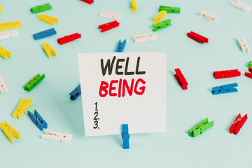 Word writing text Well Being. Business photo showcasing A good or satisfactory condition of existence including health Colored clothespin papers empty reminder blue floor background office pin
