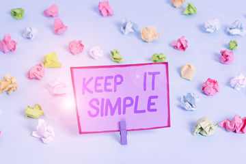Conceptual hand writing showing Keep It Simple. Concept meaning Remain in the simple place or position not complicated Colored crumpled papers empty reminder blue floor clothespin