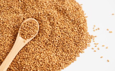 sesame seeds in wooden spoon isolated on white background.Japanese food.