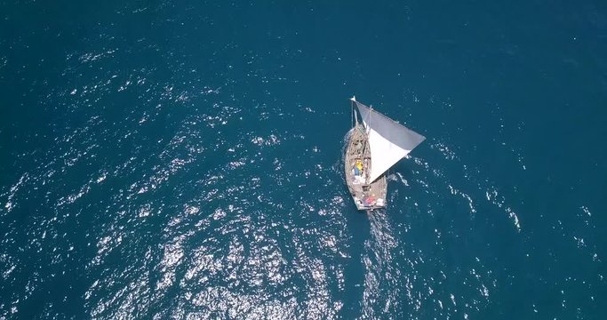 Traditional dhow sailboat sailing on the Indian ocean on the Swahili coast filmed with a drone, Tanzania.