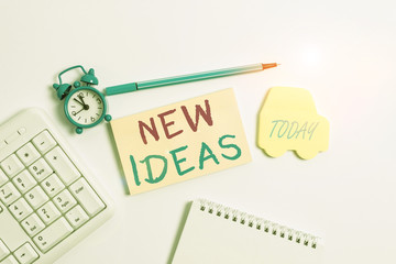 Word writing text New Ideas. Business photo showcasing something original or fresh and more effective innovation Copy space on empty note paper with clock and pencil on the table