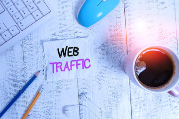 Handwriting text writing Web Traffic. Conceptual photo the amount of data sent and received by visitors to a website technological devices colored reminder paper office supplies keyboard mouse