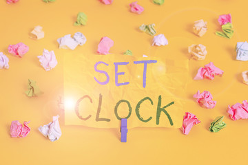 Handwriting text writing Set Clock. Conceptual photo put it to the right time or change the clock time to a later time Colored crumpled papers empty reminder white floor background clothespin