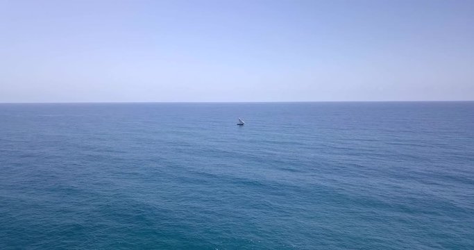 Traditional dhow sailboat sailing on the Indian ocean on the Swahili coast filmed with a drone, Tanzania.