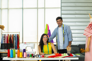 Couple fashion designers are discussing and designing their stylish cloth