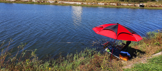 fishing in a reservoir. Multiple fishing rods are unfolded