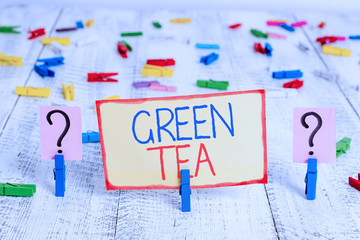 Word writing text Green Tea. Business photo showcasing type of tea that is made from Camellia sinensis leaves and buds Scribbled and crumbling sheet with paper clips placed on the wooden table