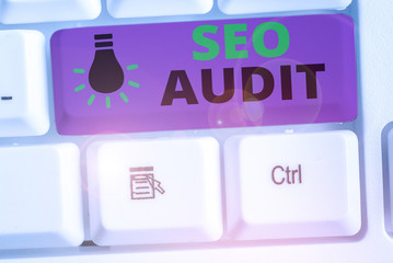 Writing note showing Seo Audit. Business concept for Search Engine Optimization validating and...