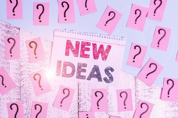 Text sign showing New Ideas. Business photo showcasing something original or fresh and more effective innovation Scribbled and crumbling papers with thick cardboard above wooden table