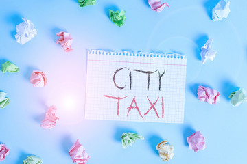 Word writing text City Taxi. Business photo showcasing type of vehicle for hire with a driver often for a nonshared ride Colored crumpled rectangle shaped reminder paper light blue background