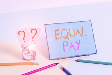 Writing note showing Equal Pay. Business concept for Rights that individuals in the same workplace be given equal pay Mini size alarm clock beside stationary on pastel backdrop