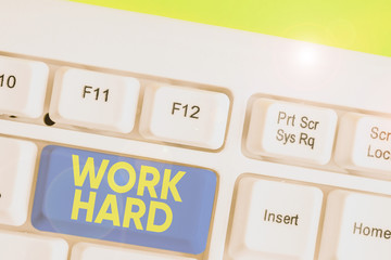 Conceptual hand writing showing Work Hard. Concept meaning Laboring that puts effort into doing and...