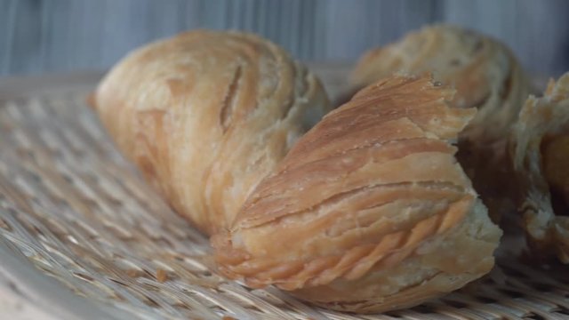 Cinematic closed up shot of Curry puff or locally known as &ldquo;Karipap&rdquo; is a Malaysian traditional food. This tasty food have flaky pastry on the outside and delicious curry potato on the inside