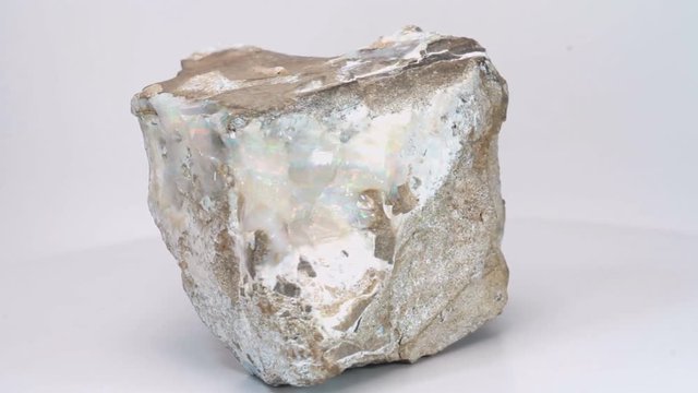 View on a white background, nugget of Australian opal. Beautiful semiprecious stone.