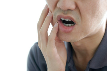 Young man used his hands to touch the cheek. With toothache, suffering, unhappy From oral problems