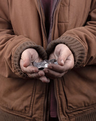 beggar concept. outstretched hands of a homeless person asking for help. silver coins in the palms