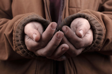 beggar concept. poor man asks for cash assistance. silver coins in the palms