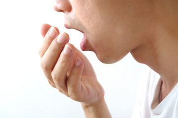 Oral health Men use hands to check for bad breath and breathe.
