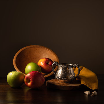 Apples in Wooden Bowl with Antique Silver Cup and Garlic