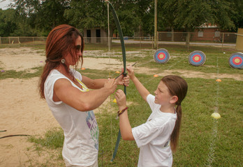 Mother and daughter doing archery