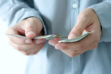 Business man's hand works for the money, He offer banknotes with partner for investment business,...