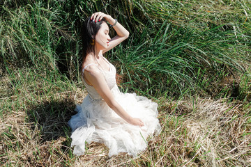 Fototapeta na wymiar Portrait young beautiful asian woman in white dress relaxing at flower garden