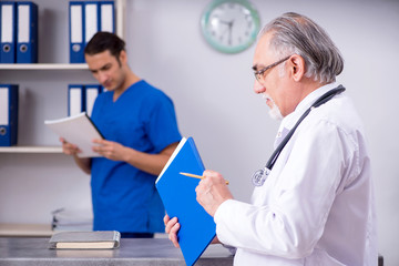 Two doctors talking at the reception in hospital