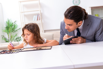 Child psychologist attending small girl