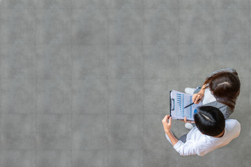 Top view of young asian business team standing, talking and reporting with annual report document...