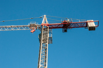 Naklejka premium A working Construction Sky Crane on a new high rise multistory building site with blue sky background. Australia.