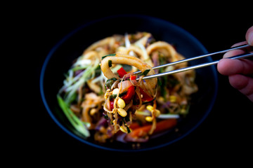 Spicy sauced stir-fried squid, pick it up with chopsticks