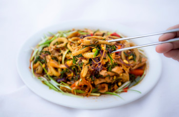 Spicy sauced stir-fried squid, pick it up with chopsticks