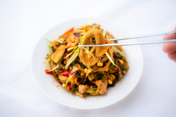 Spicy sauced stir-fried squid, pick it up with chopsticks